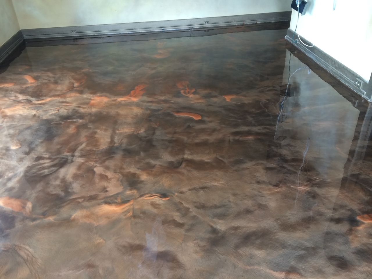A close up of a brown metallic floor in a room.
