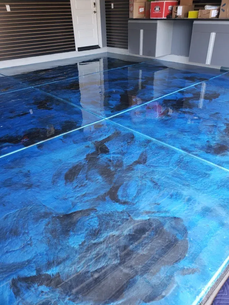 A blue and black epoxy floor in a garage.