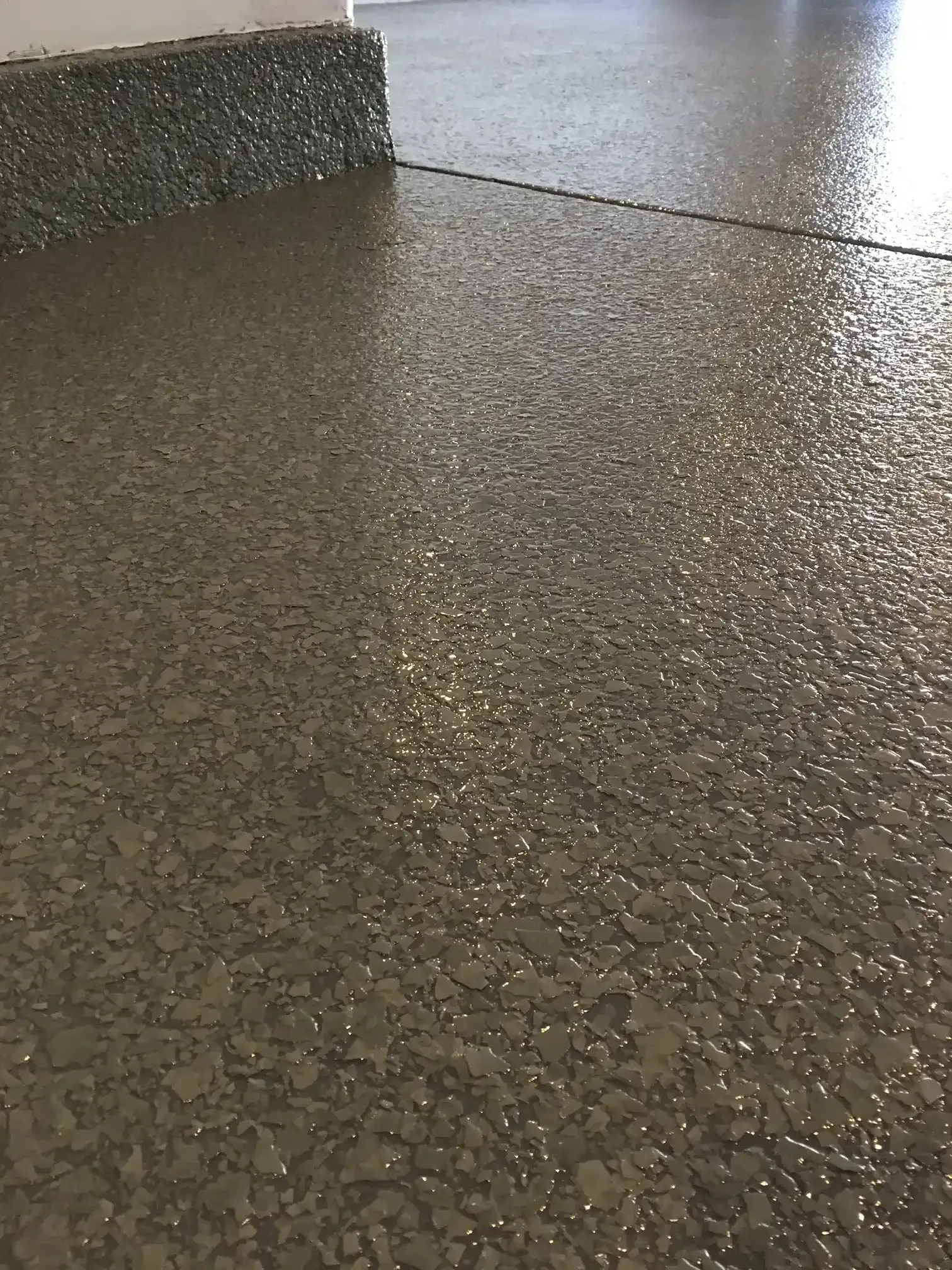 A close up of a shiny concrete floor in a garage.