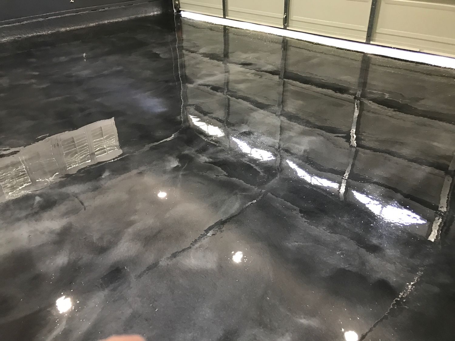 A close up of a black metallic floor in a garage.