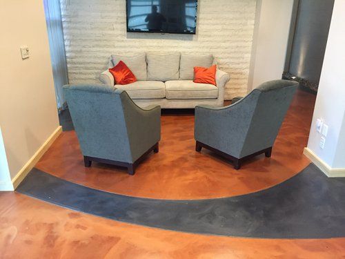 A living room with a couch , chairs , and a flat screen tv.