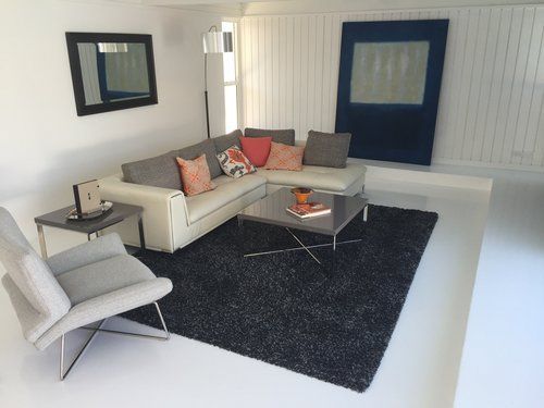 A living room with a couch a chair and a coffee table