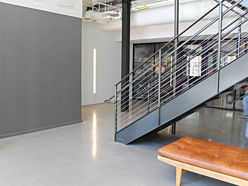 A person is walking down a set of stairs in a building.