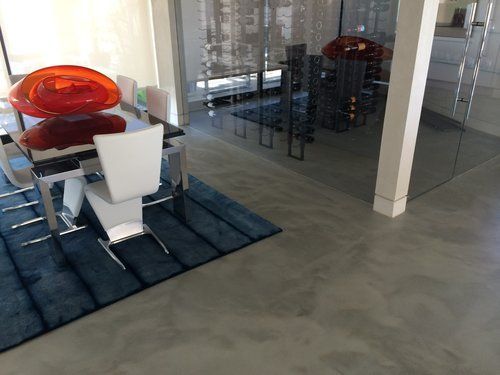 A dining room with a table and chairs and a blue rug