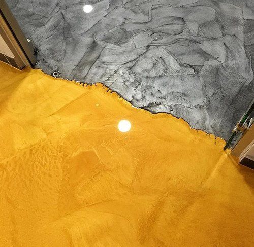 A yellow and gray floor with a door in the background.