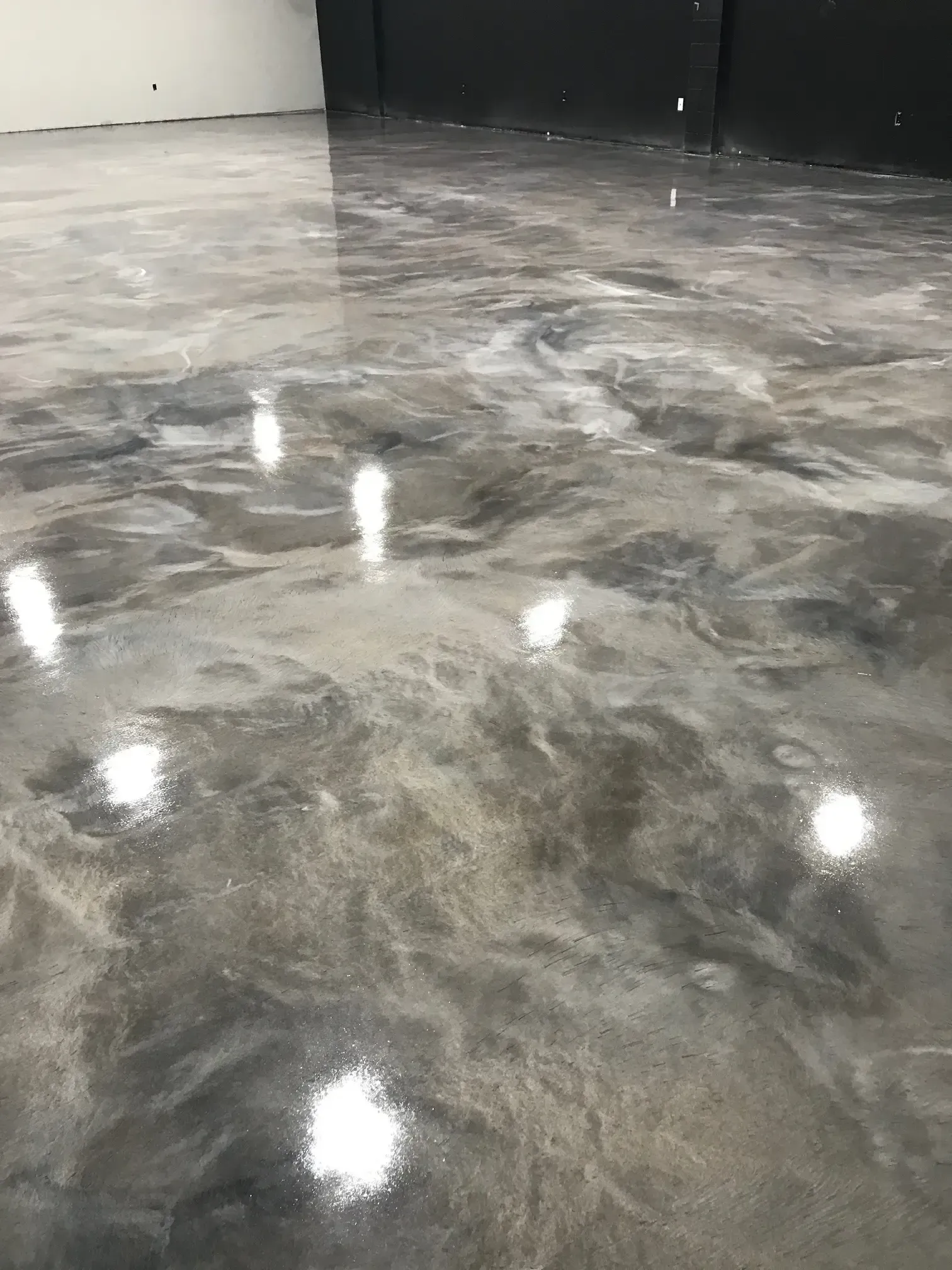 A close up of a shiny metallic floor in a garage.