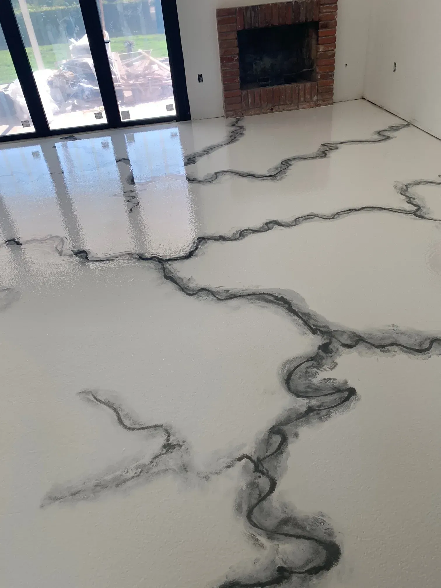 A living room with a white floor and a fireplace.