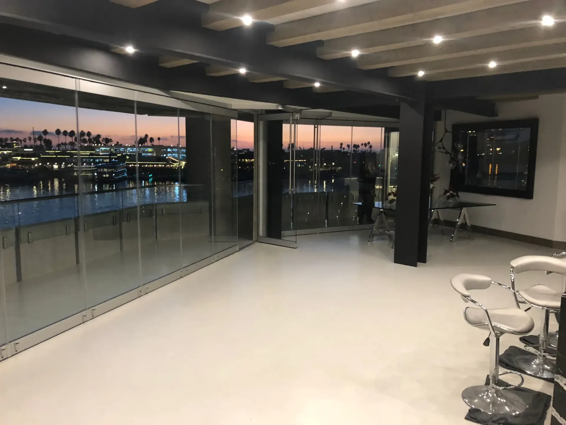 A large room with a lot of windows and stools.