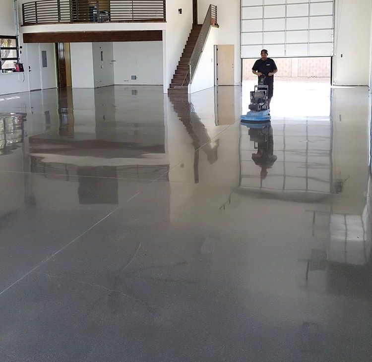 A man is polishing the floor of a building