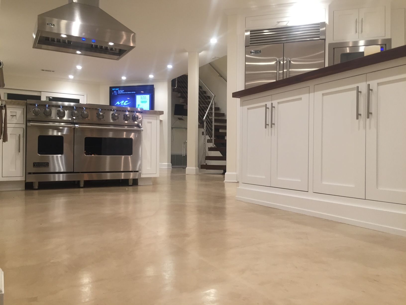 A kitchen with stainless steel appliances and white cabinets