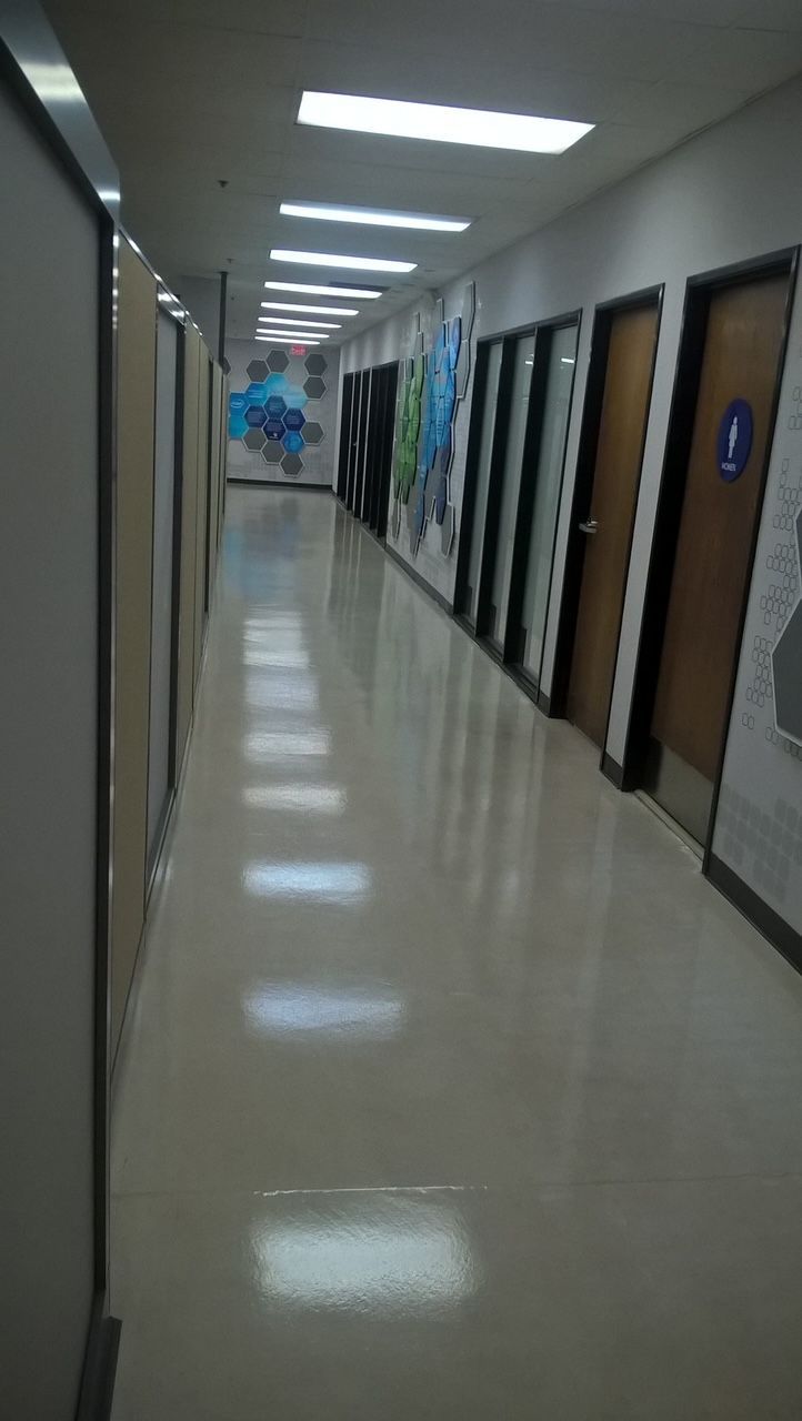 A long hallway in a building with lots of doors