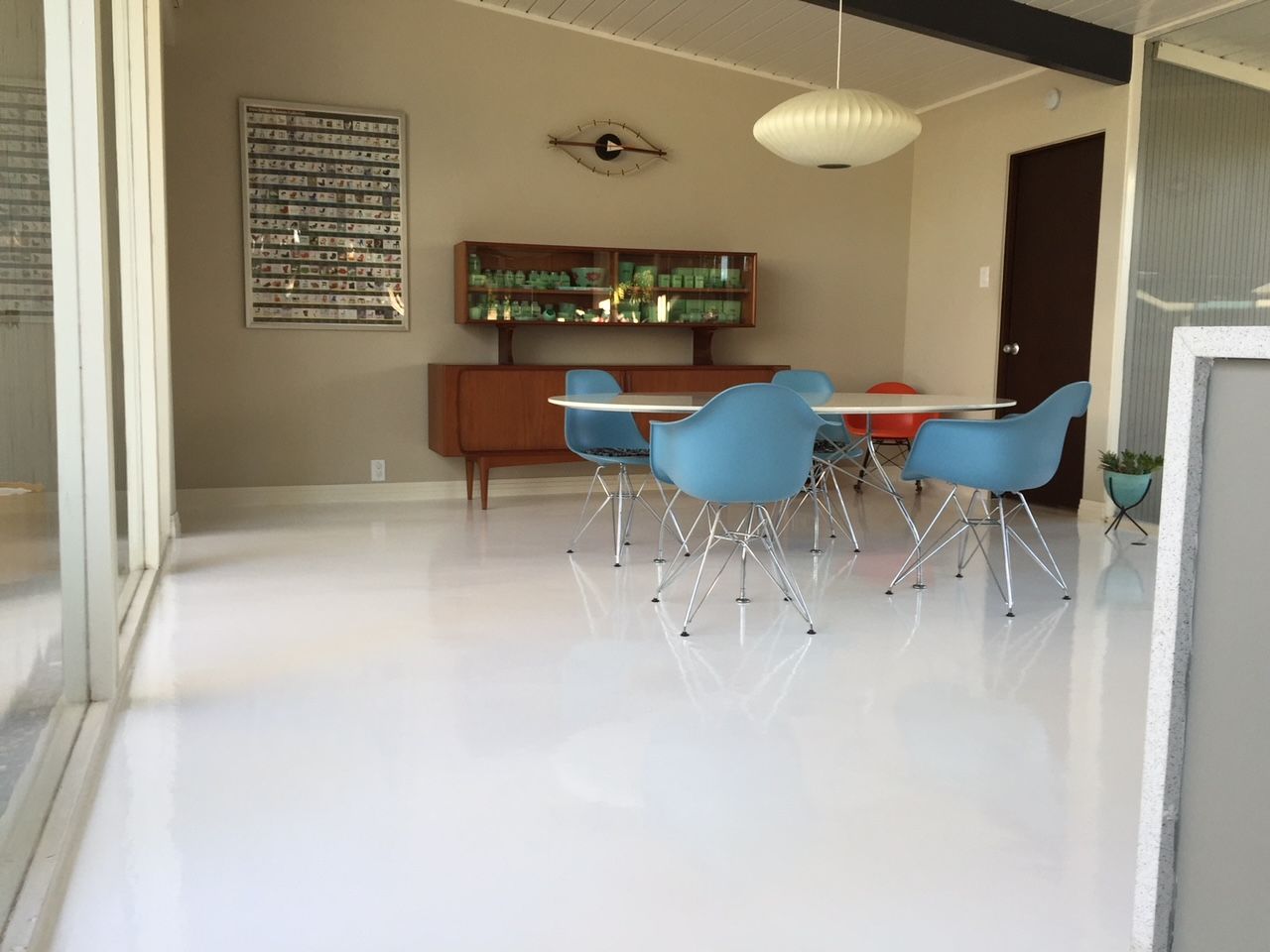 A dining room with blue chairs and a table