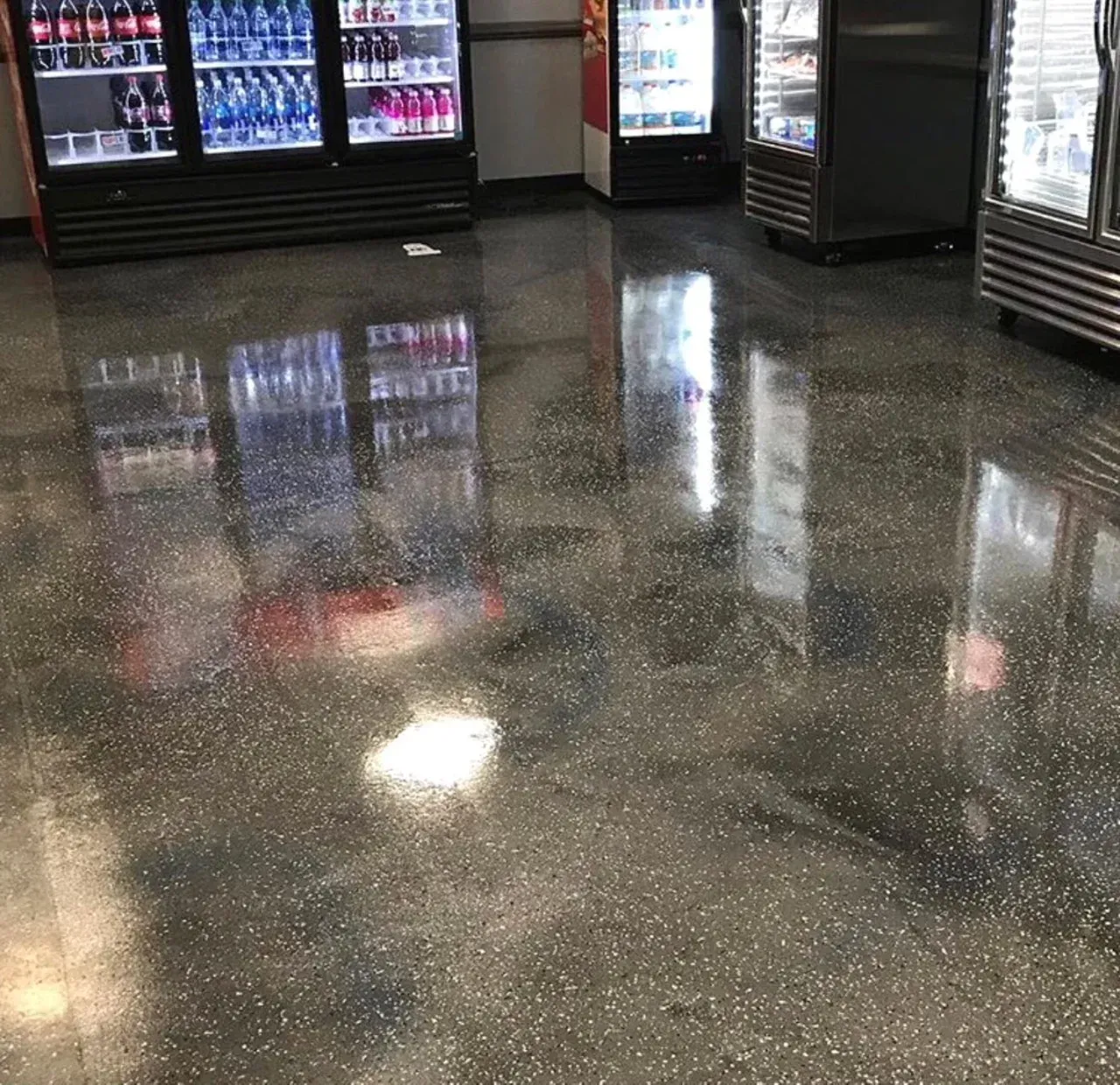 A room with a lot of fridges and a shiny floor