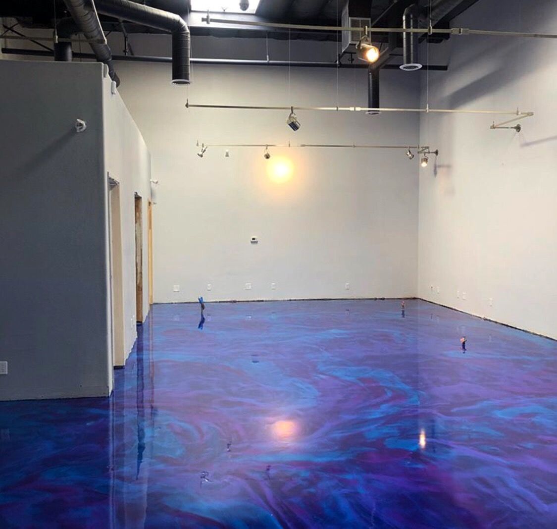 An empty room with a blue and purple floor