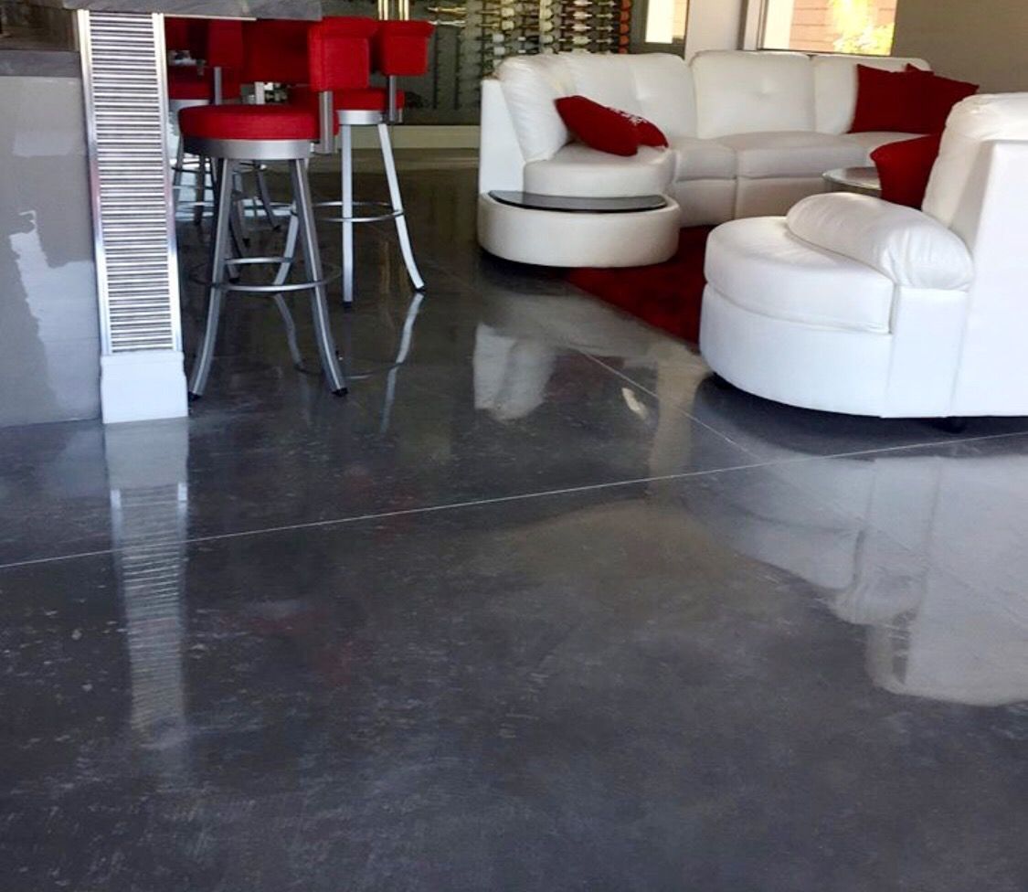 A living room with a white couch and red chairs