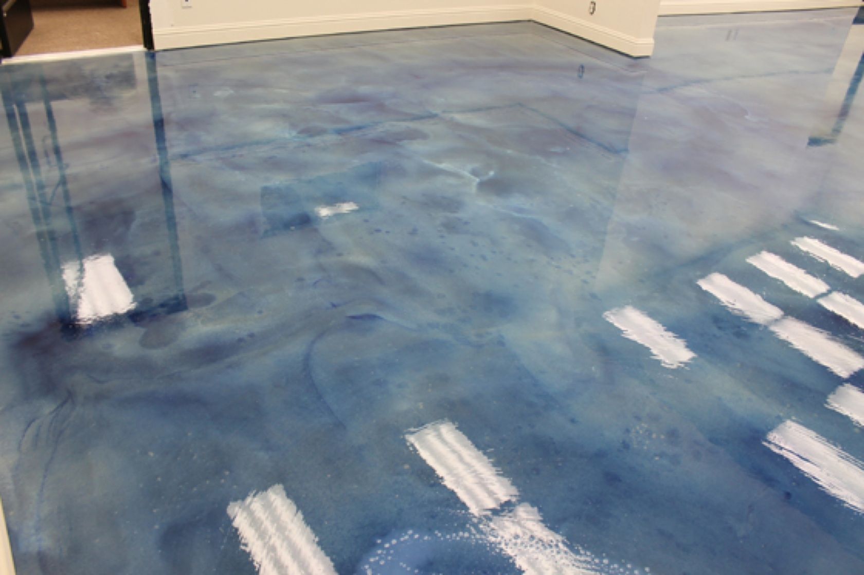 A blue metallic floor with a wheelchair symbol on it.