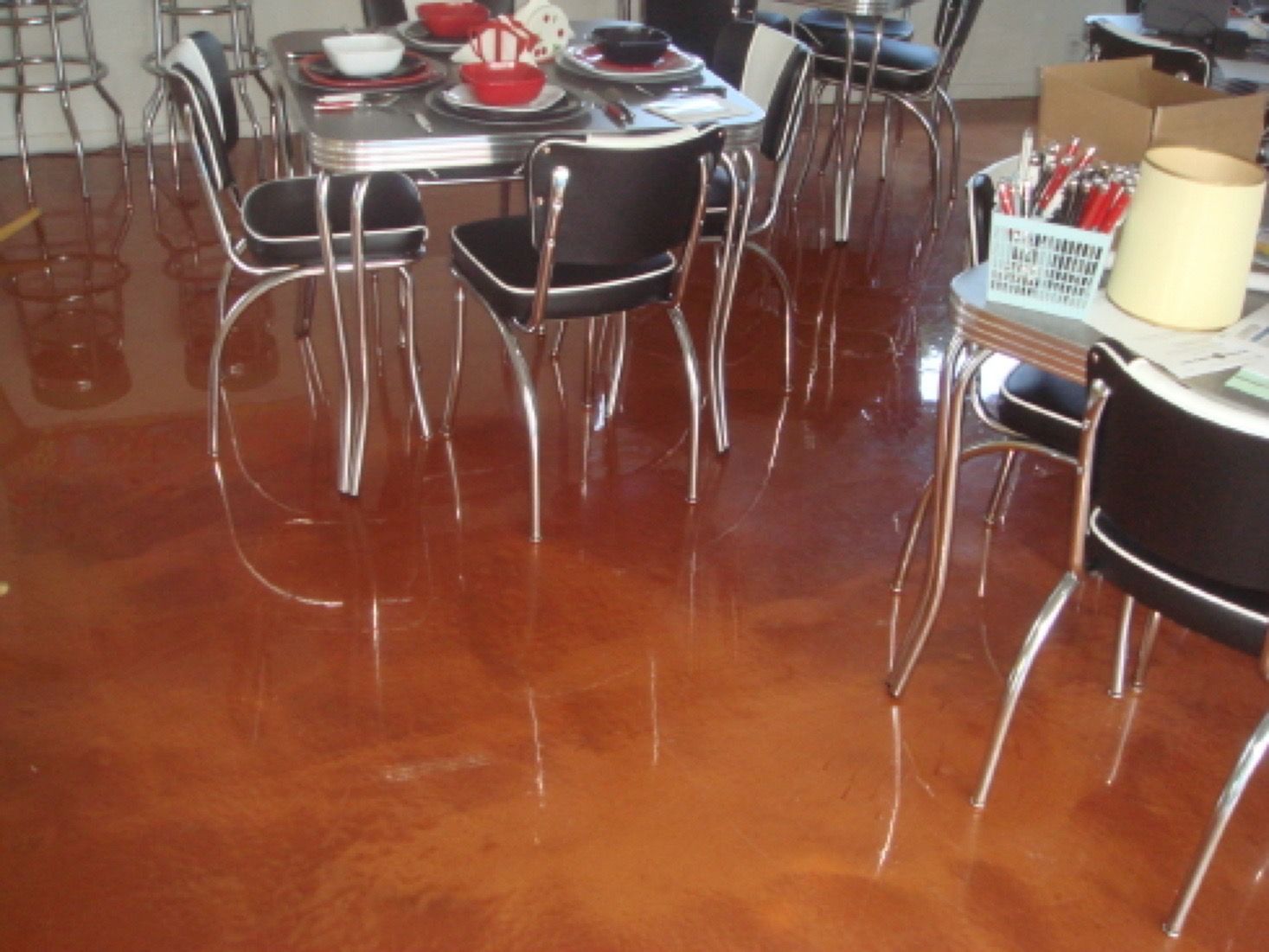 A dining room with tables and chairs and a shiny floor
