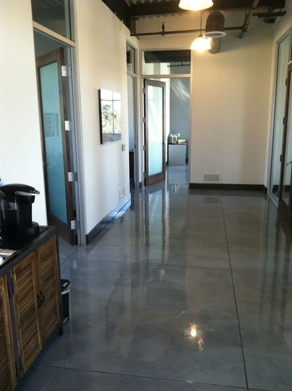 A hallway with a coffee maker on the counter