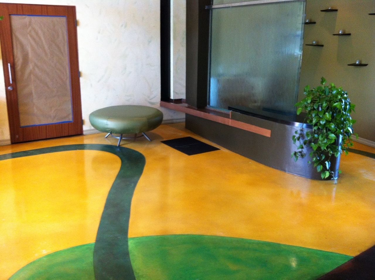 A living room with a yellow and green floor