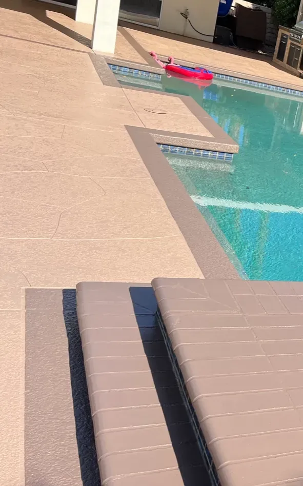 A swimming pool with stairs leading up to it