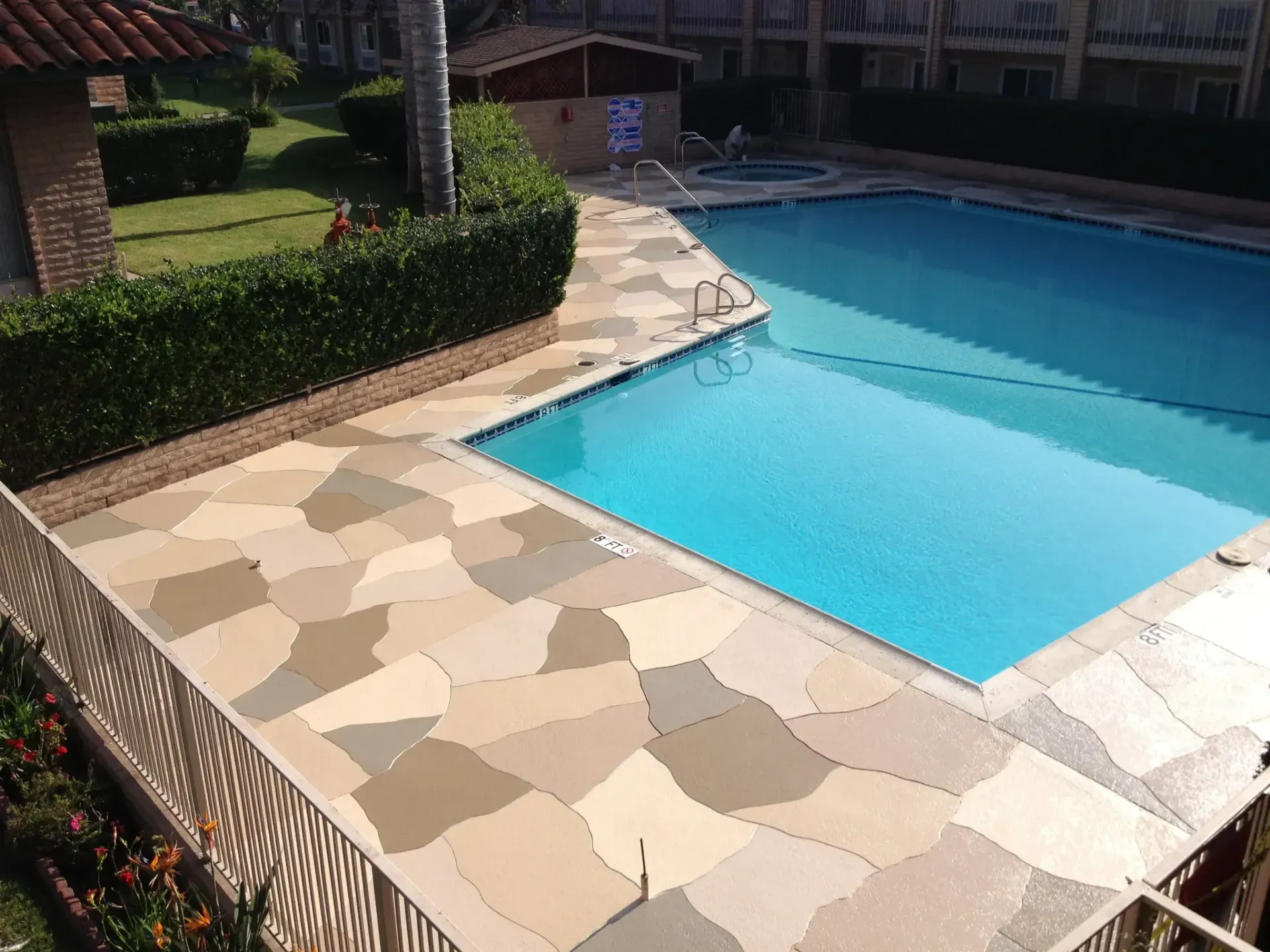 A large swimming pool with a fence around it