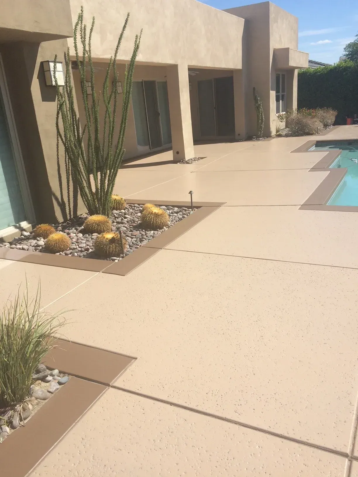 There is a swimming pool in the backyard of a house.
