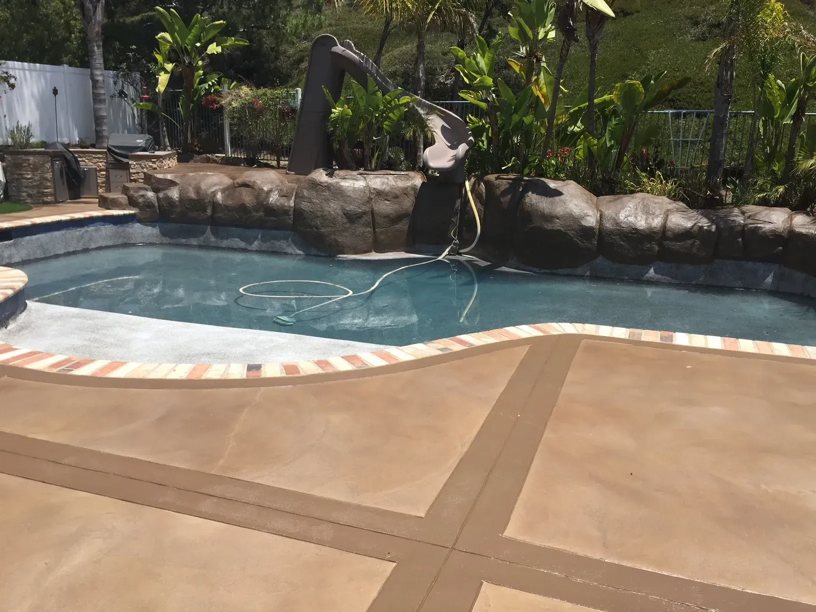 A large swimming pool with a waterfall in the background