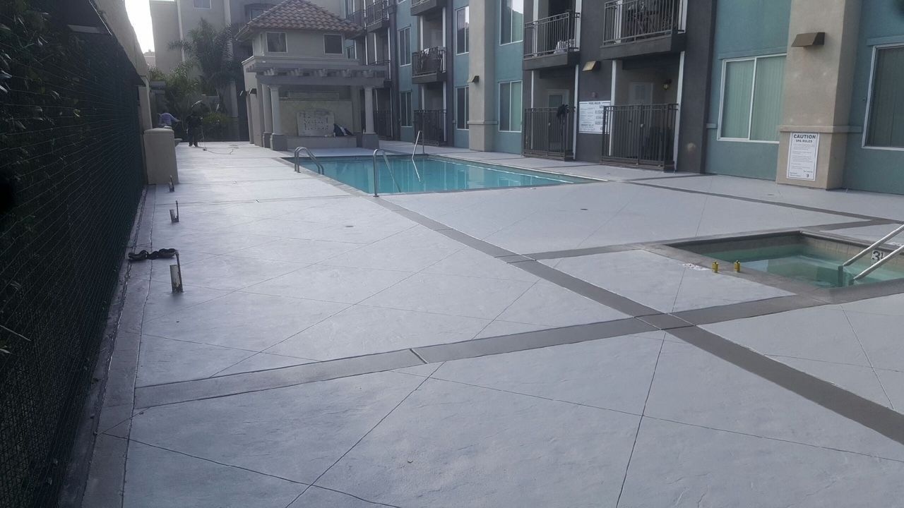 There is a large swimming pool in the middle of a building.