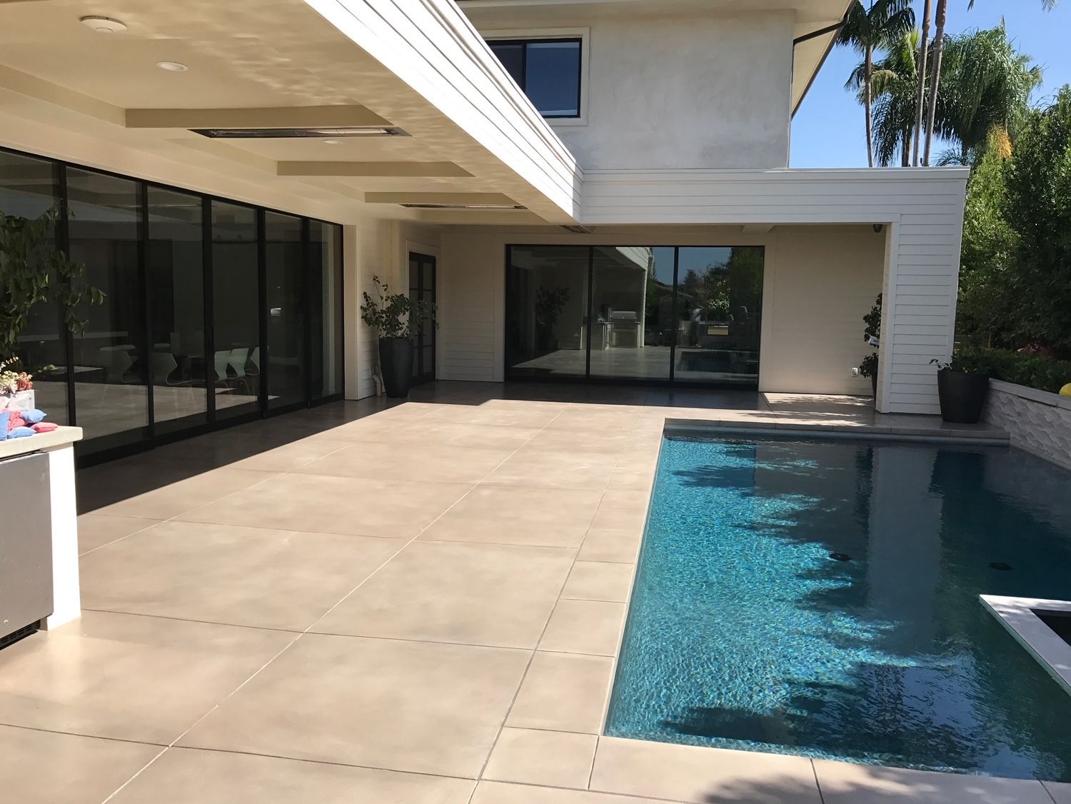 A large house with a swimming pool in front of it