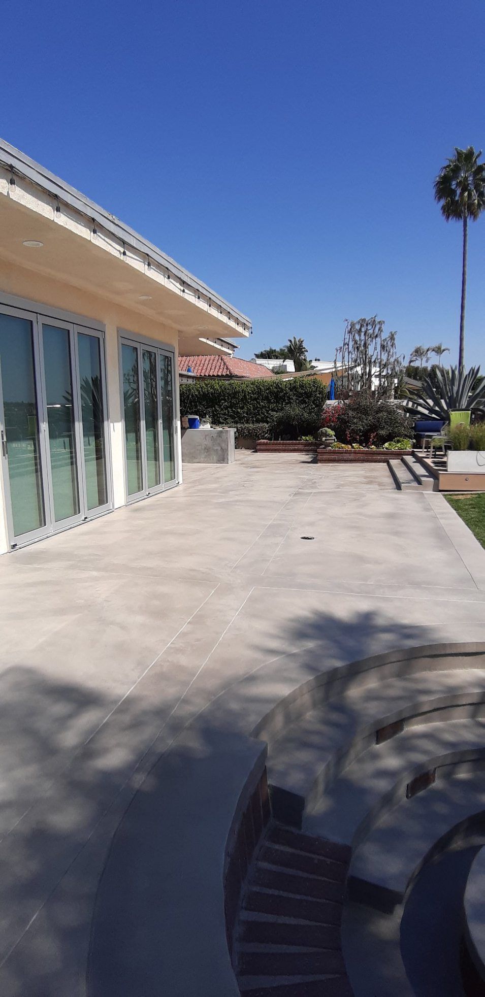 A large house with a lot of windows and a patio in front of it.