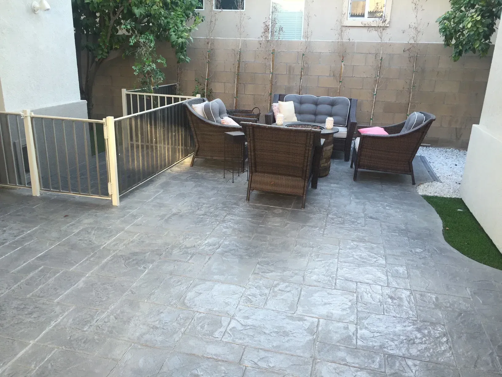 A patio with a couch , chairs , and a table