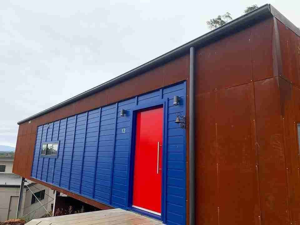 A Blue and Red House with A Red Door — Bay Coast Electrical & Control Solutions in Maloneys Beach, NSW