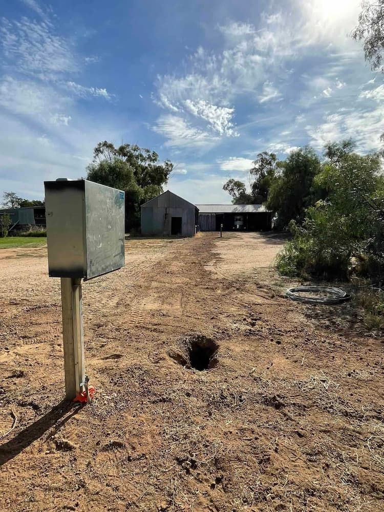 A Mailbox Is Sitting in The Middle of A Dirt Field — Bay Coast Electrical & Control Solutions in Maloneys Beach, NSW