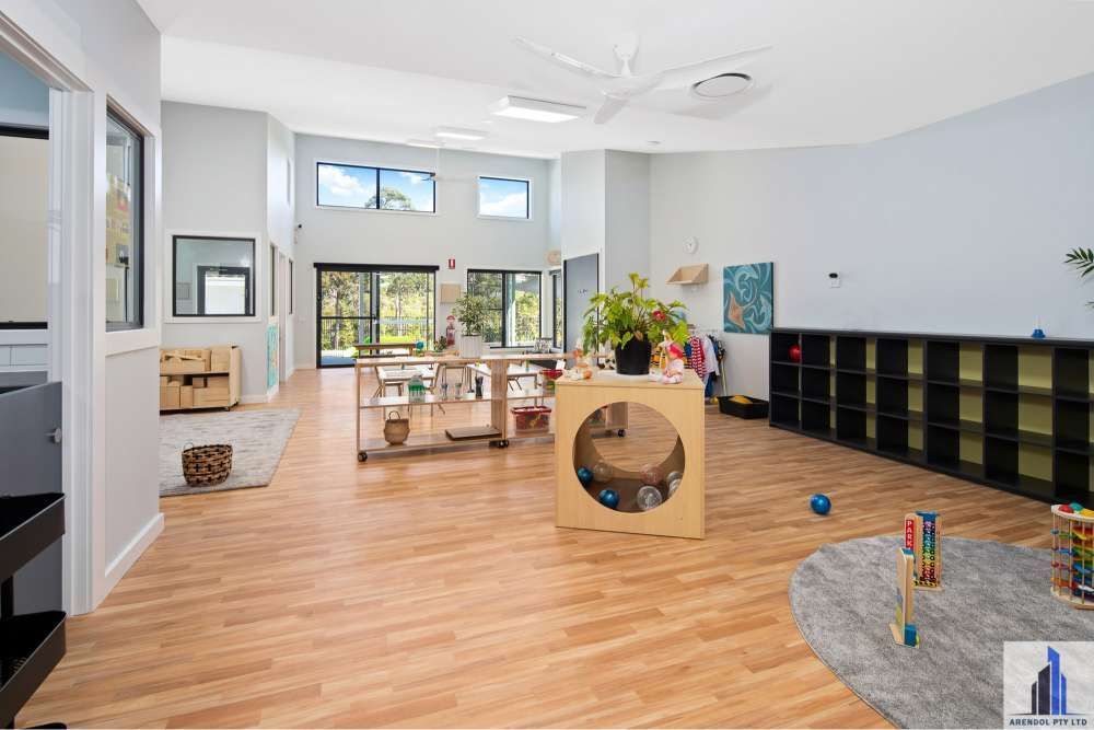 A Large Room With Wooden Floors And Lots Of Shelves And Toys — BayCoast Electrical & Control Solutions in Ulladulla, NSW