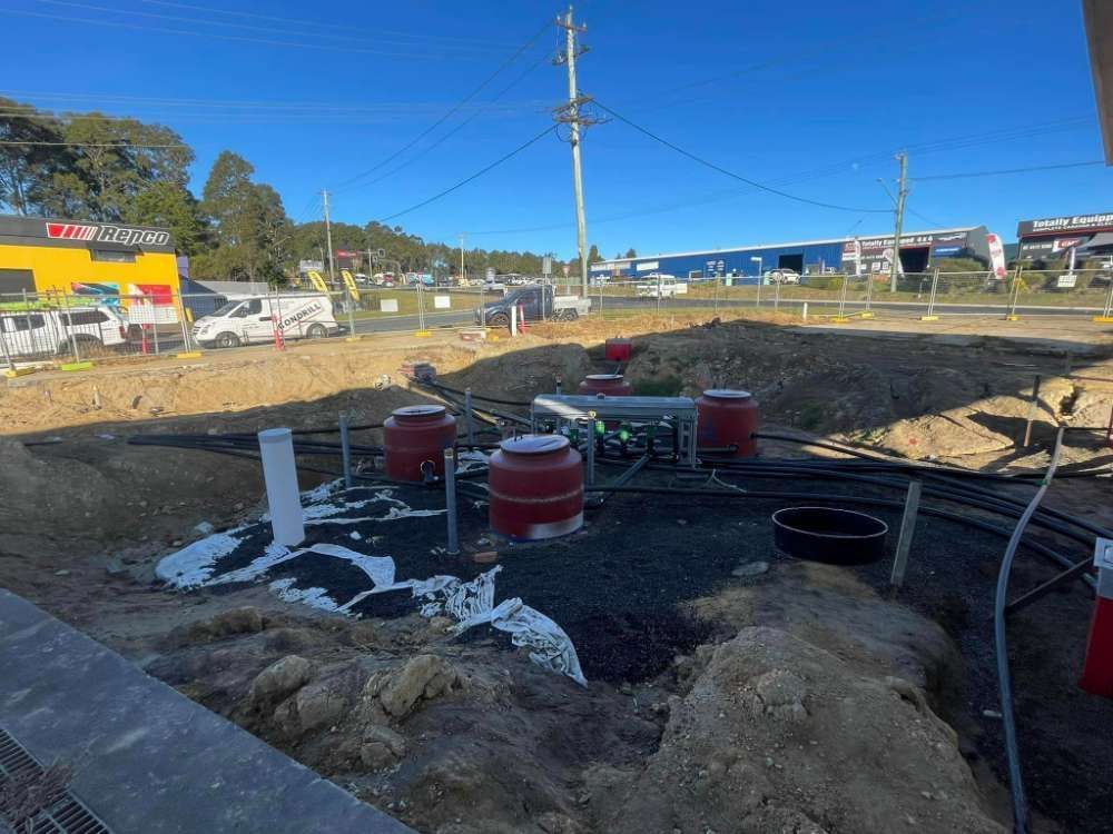 A Train Track Is Being Built In A Dirt Field — BayCoast Electrical & Control Solutions in Ulladulla, NSW