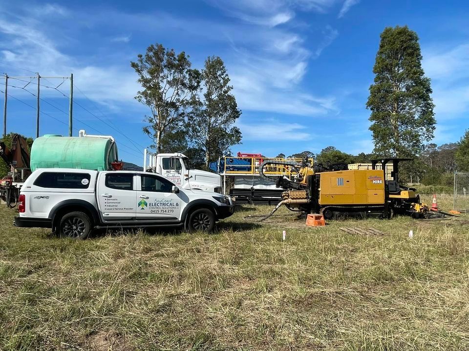 A Truck Is Parked Next To A Machine In A Field — BayCoast Electrical & Control Solutions in Braidwood, NSW