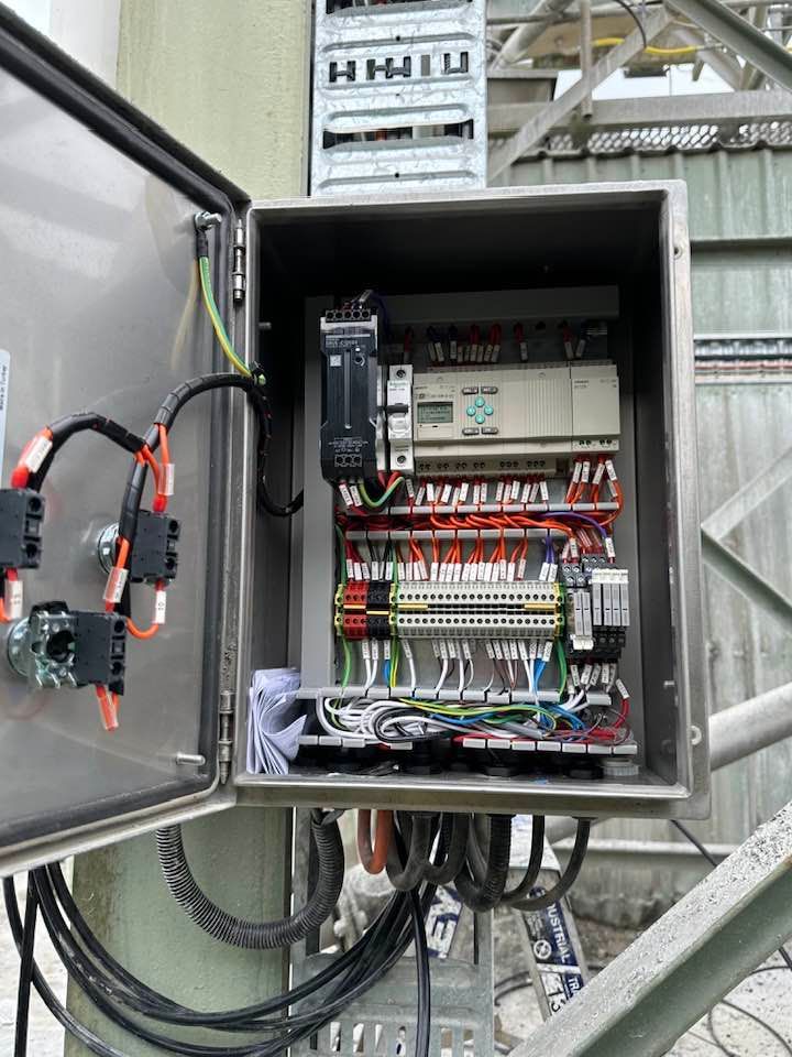 A Stainless Steel Box With A Lot Of Wires Coming Out Of It — BayCoast Electrical & Control Solutions in Maloneys Beach, NSW