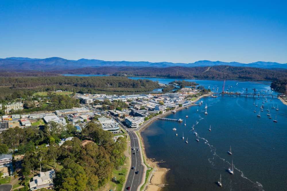 An Aerial View Of A City Surrounded By Water And Mountains — BayCoast Electrical & Control Solutions in Batemans Bay, NSW