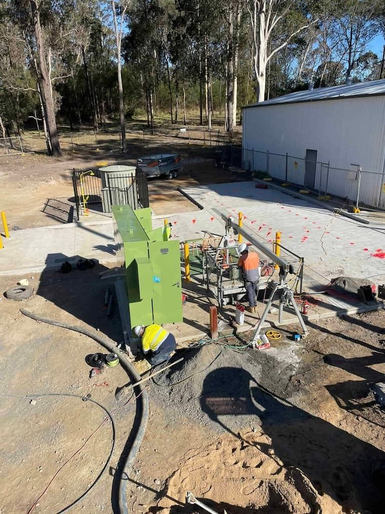 A Group of Construction Workers Are Working on A Construction Site — Bay Coast Electrical & Control Solutions in Maloneys Beach, NSW