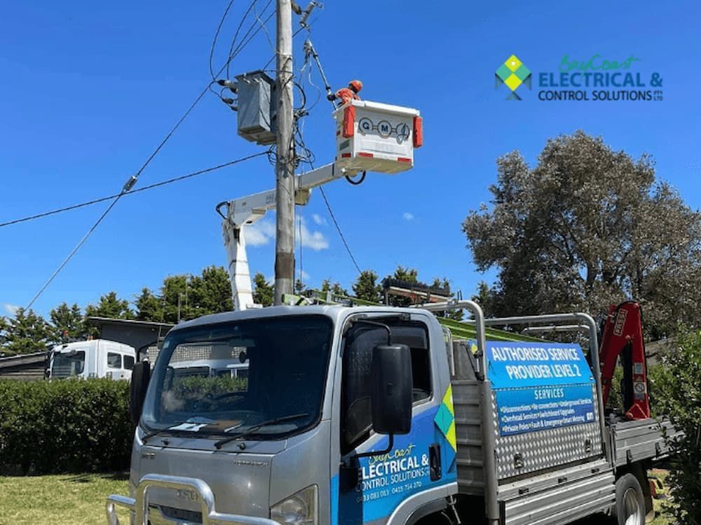 An Electrical Truck Is Parked Next to A Power Pole — Bay Coast Electrical & Control Solutions in Maloneys Beach, NSW