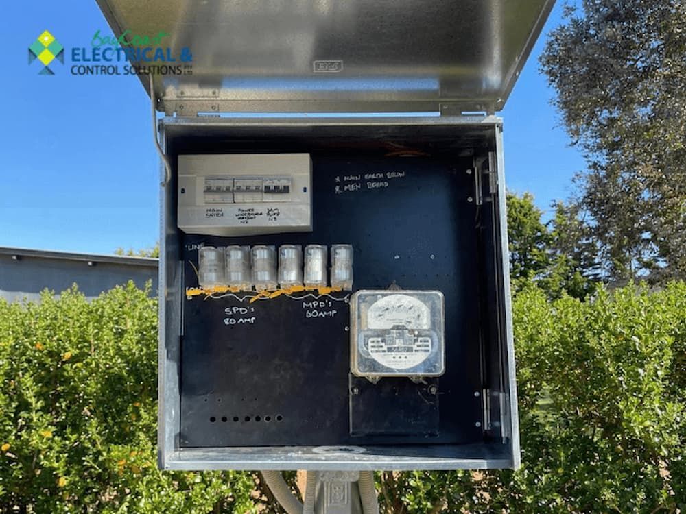 An Electrical Box Is Sitting on Top of A Metal Pole — Bay Coast Electrical & Control Solutions in Maloneys Beach, NSW