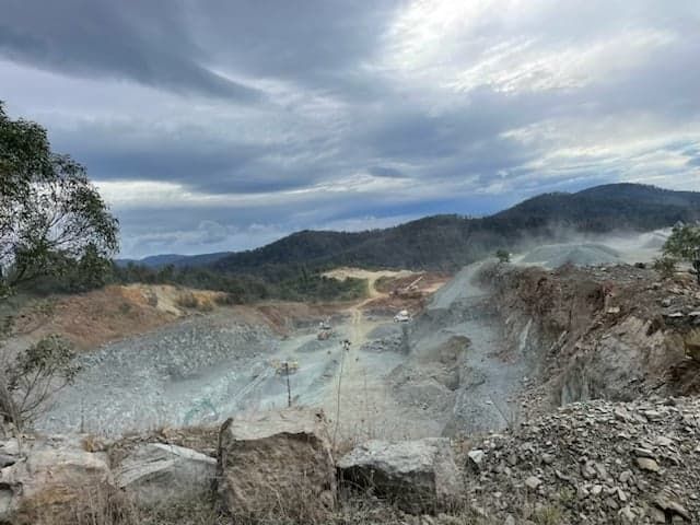 A Large Rocky Area with Mountains in The Background and A Lot of Rocks in The Foreground — Bay Coast Electrical & Control Solutions in Maloneys Beach, NSW