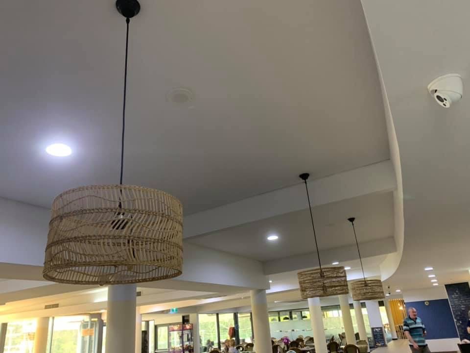 A Restaurant With Wicker Lamps Hanging From The Ceiling — BayCoast Electrical & Control Solutions in Narooma, NSW