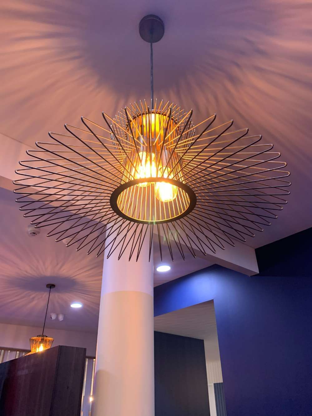 A Pendant Light Is Hanging From The Ceiling In A Room — BayCoast Electrical & Control Solutions in Maloneys Beach, NSW