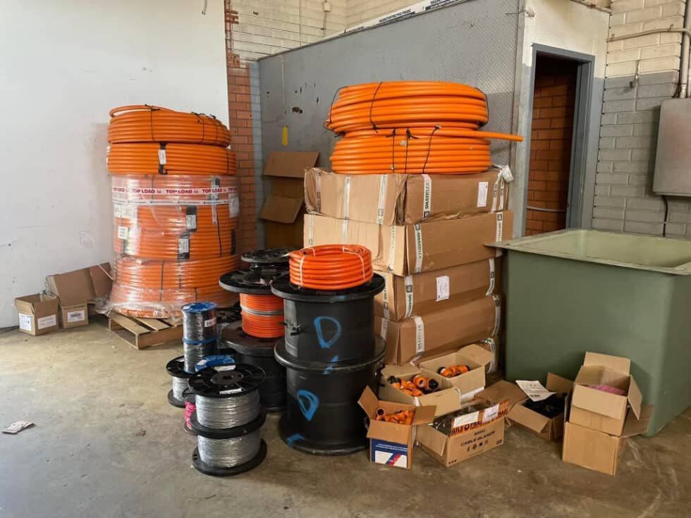 A Bunch Of Boxes Are Stacked On Top Of Each Other In A Room — Bay Coast Electrical & Control Solutions in Maloneys Beach, NSW