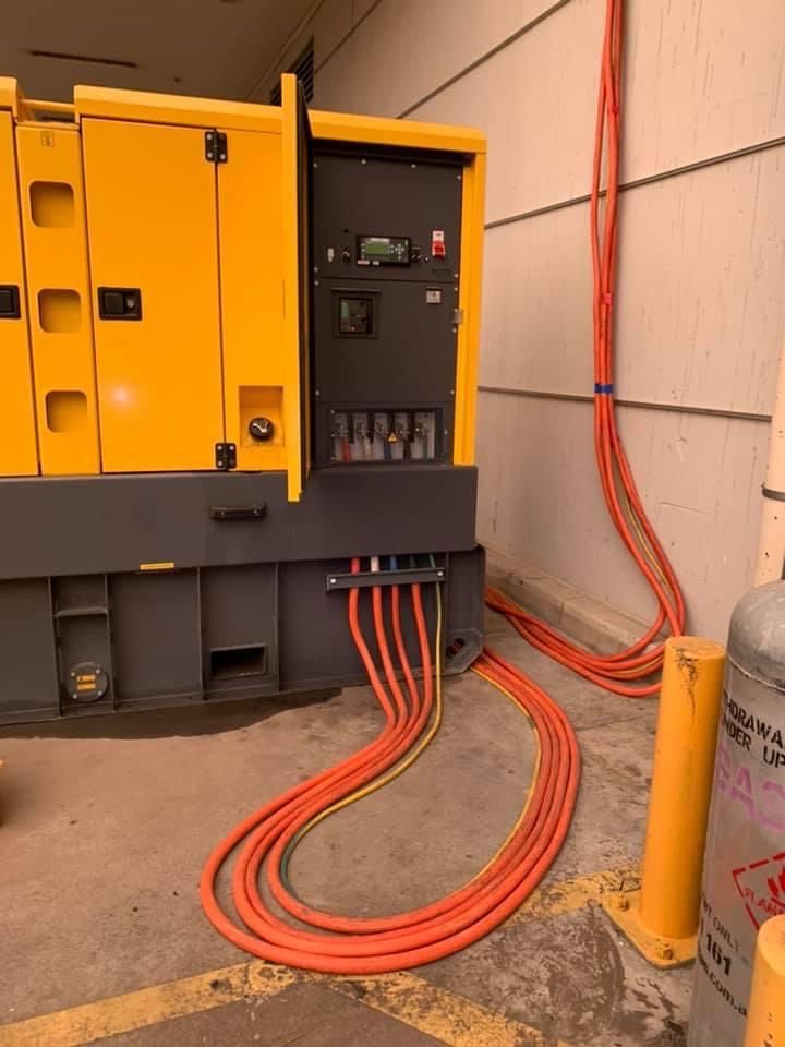 A Yellow Generator With Red Wires Attached To It — BayCoast Electrical & Control Solutions in Batemans Bay, NSW
