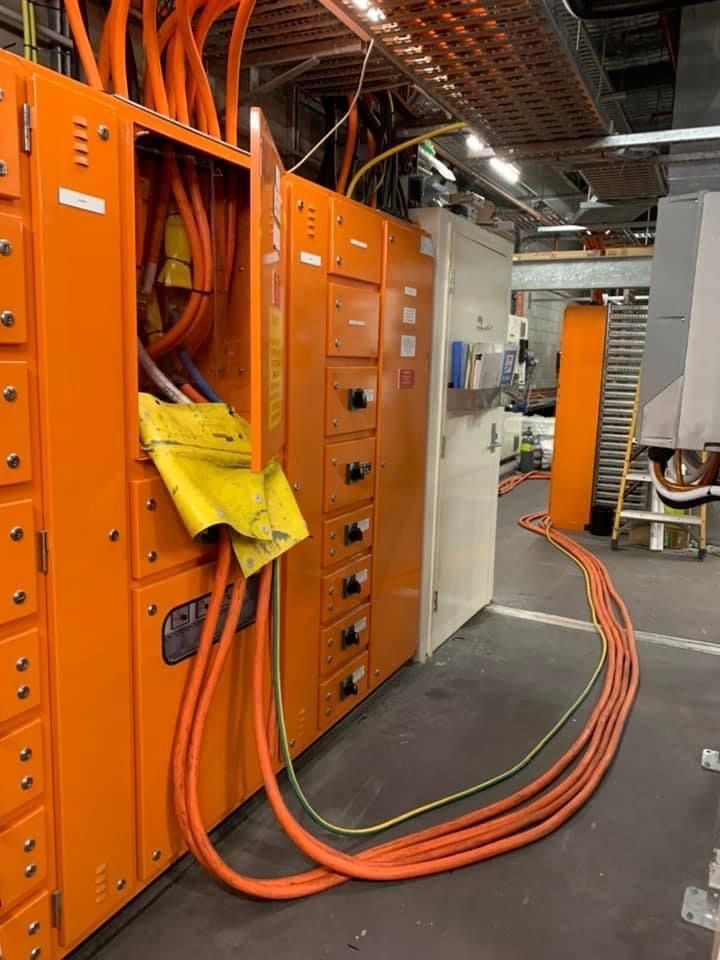 A Bunch Of Orange Wires Are Connected To An Orange Box In A Room — BayCoast Electrical & Control Solutions in Narooma, NSW