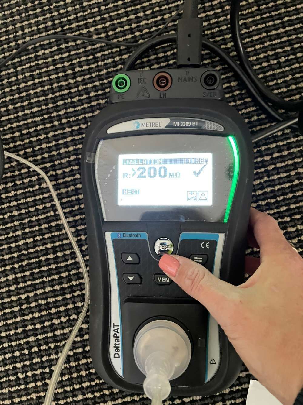 A Person Is Holding A Device With A Screen That Says 200m On It — BayCoast Electrical & Control Solutions in Maloneys Beach, NSW