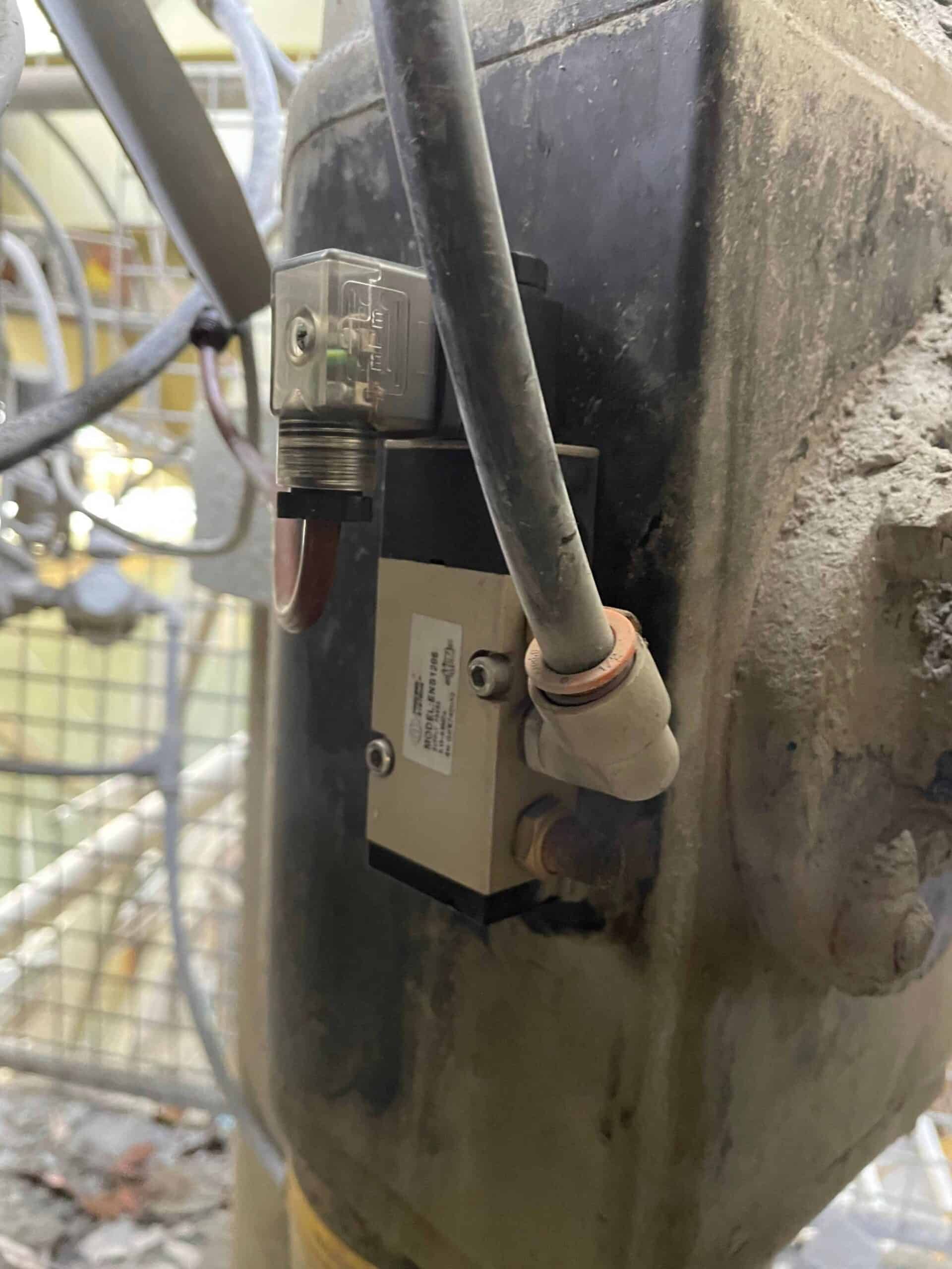 A Valve Is Attached to The Side of A Dirty Tank — Bay Coast Electrical & Control Solutions in Maloneys Beach, NSW