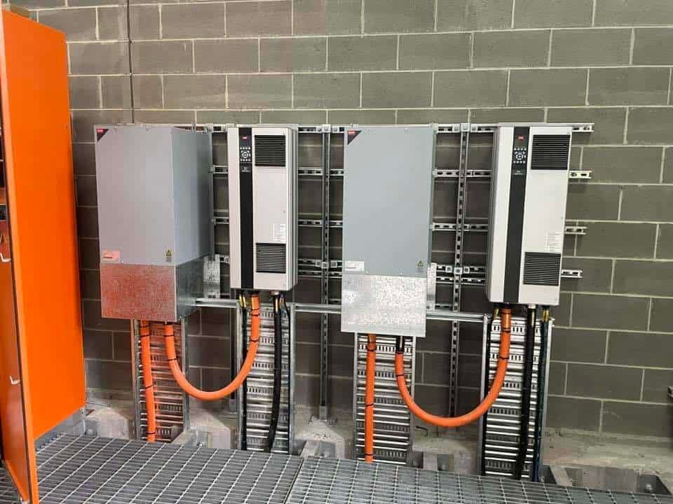 A Row of Electrical Boxes Hanging on A Brick Wall — Bay Coast Electrical & Control Solutions in Maloneys Beach, NSW